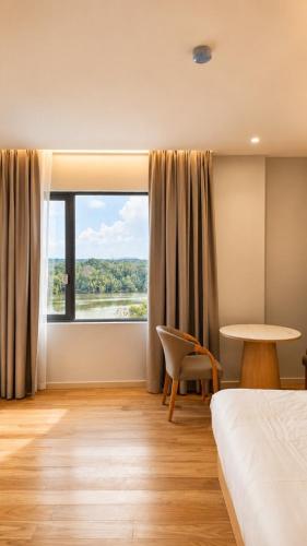 a room with a bed and a large window at H&H Boutique Hotel in Cukai