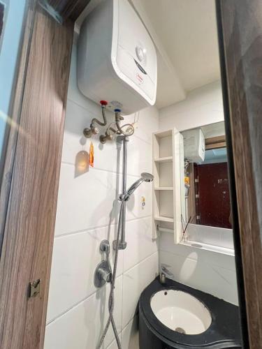 a small bathroom with a toilet and a shower at Sky House BSD By Micky Studio in Cilenggang