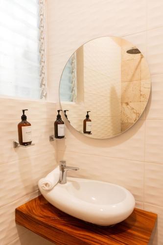 a bathroom with a sink and a mirror at Casa MarEscondido in Puerto Escondido