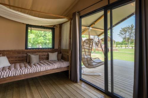a room in a tent with a swing at Glamping Tenuta Ca'Nova in Mestrino