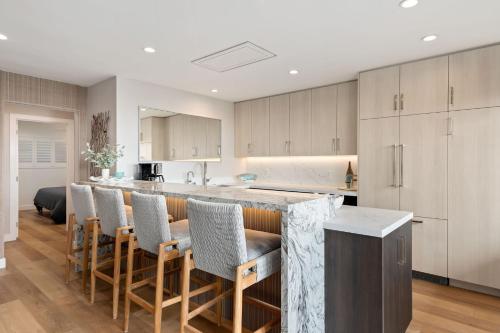 a kitchen with a bar with chairs around it at Carpinteria Shores CS 105 in Carpinteria