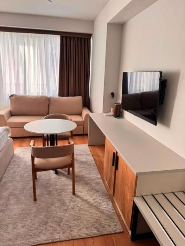 a living room with a couch and a table at Ilshat mini hotel in Cholpon-Ata