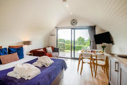 a room with a bed and a table with chairs at 2 Bed in Corwen oc-80318 in Gwyddelwern
