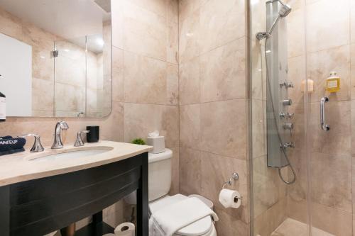 a bathroom with a shower and a toilet and a sink at Madison Square Studio at Return Policy Broadway in New York