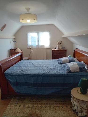 a bedroom with a blue bed and a window at oiseau bleu in Dieppe