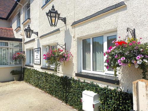 a building with flower boxes on the side of it at Brigstock House in Llandudno
