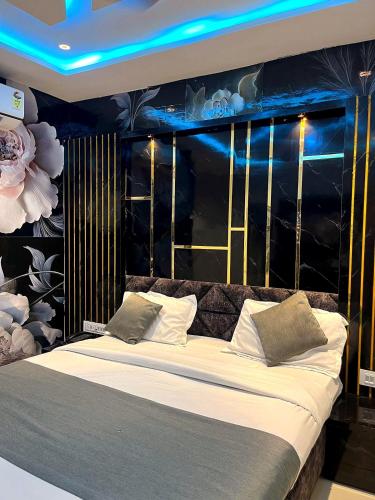 a bedroom with a large bed with blue lights on it at Hotel prime View in Ahmedabad