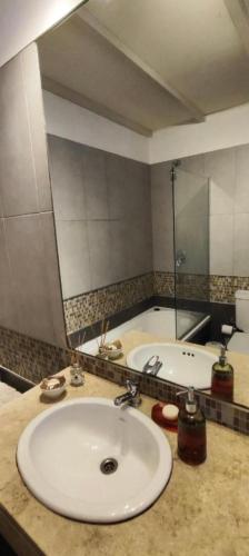 a bathroom with a sink and a large mirror at Departamento MOCA - Full Amenities in Buenos Aires