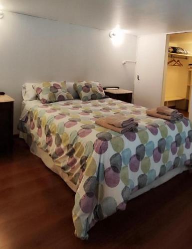 a bedroom with a large bed with a colorful comforter at Departamento MOCA - Full Amenities in Buenos Aires