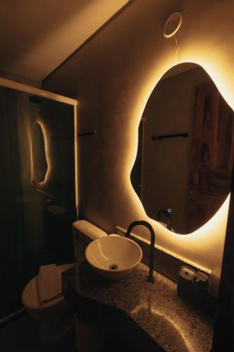 a bathroom with a sink and a mirror at Kitecabana Pousada in Cumbuco