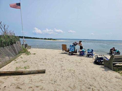 a man standing on a beach with two children in strollers at Minnehaha Marvel in Southold