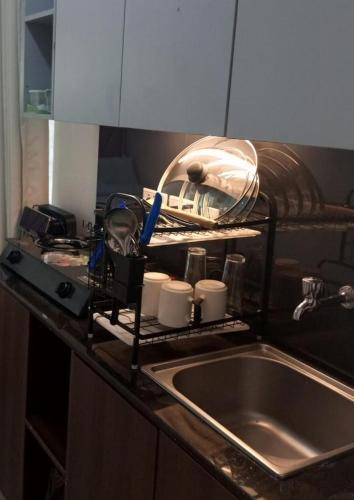 a kitchen counter with a sink next to a kitchen counter sidx sidx sidx at Eden Homes in Nairobi