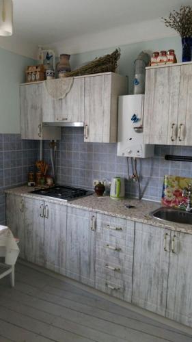 a kitchen with white cabinets and a counter top at Eco-Apartment in Province Style in Myrhorod