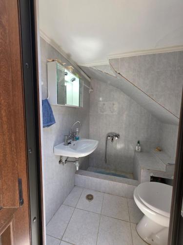 a bathroom with a sink and a toilet at Sidirounta Traditional Home 2 in Chios