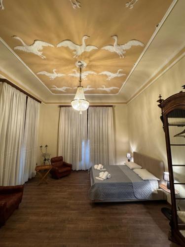 a bedroom with a bed and a ceiling with birds on it at Villa Luisetta Palmi in Palmi