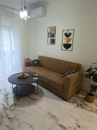 a living room with a couch and a table at Cloud9 Apartment in Kavála