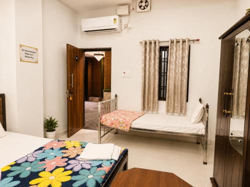 a room with two beds and a window at Shri Shyam Kunj Hotel in Ambikāpur