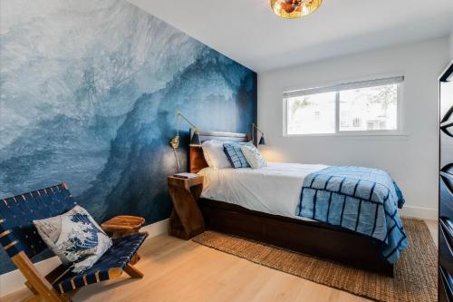 a bedroom with a large wave mural on the wall at Bella Blu in Avila Beach