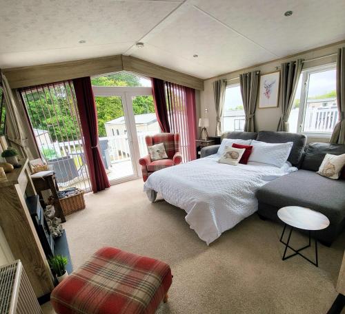 a bedroom with a bed and a couch at Bracken Lodge in Bucks Mills