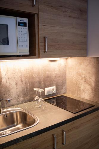 a kitchen with a sink and a microwave at Holzmannhof in Flachau