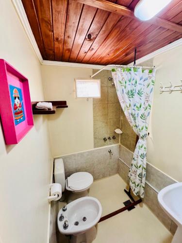a bathroom with a toilet and a sink at Hostal del Suri in Cafayate