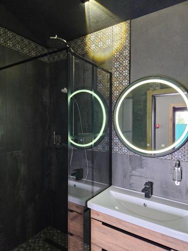 a bathroom with a sink and a mirror at BAVARO HOTEL and SPA in Oral