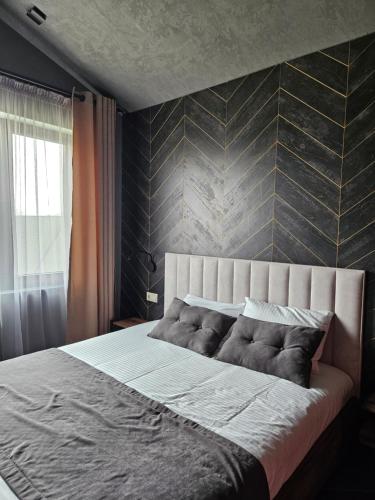 a bedroom with a large bed with a wall at BAVARO HOTEL and SPA in Oral