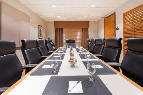 a conference room with a long table and chairs at Wingate by Wyndham Calgary South in Calgary