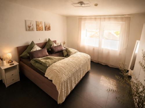 a bedroom with a bed with a window at Ferienwohnung Elya Gartenparadies nahe Events, Outlet und Spa in Bad Münstereifel