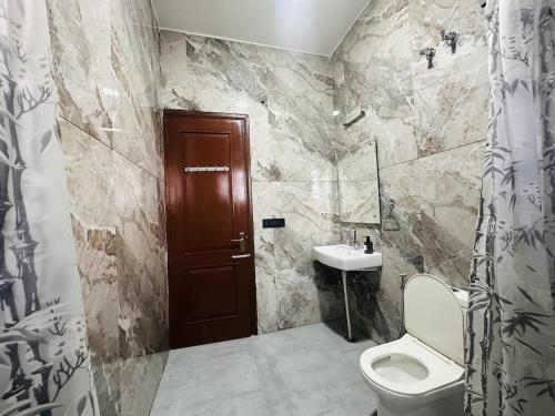 a bathroom with a toilet and a sink at Comfy Corner in Chandīgarh