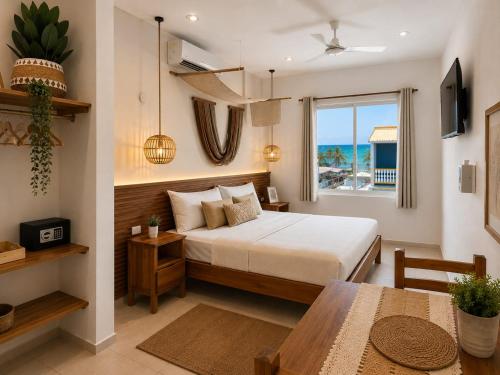 a bedroom with a bed and a table and a window at Hotel Isla Mujeres Centro & Beach Club Included in Isla Mujeres
