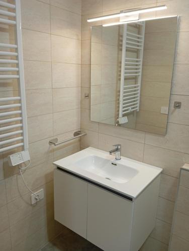 a bathroom with a white sink and a mirror at Villa Maldera-case vacanza-loft- loft queen specchio in Trani