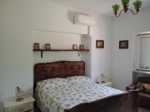 a bedroom with a bed and a couch and a window at Fosso Marchese in Cusano Mutri