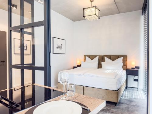 a bedroom with a bed and a table with a sink at ELBE6 Apartments in Wittenberge
