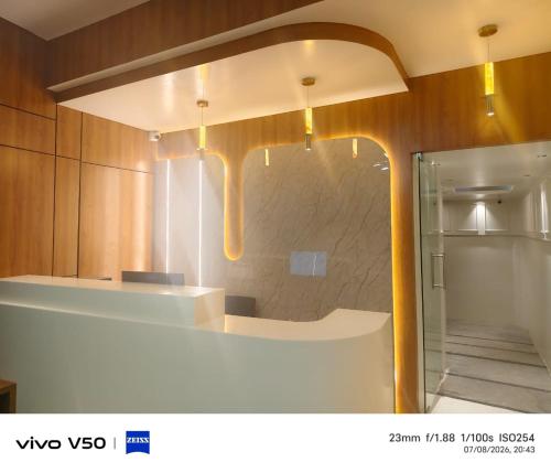 a kitchen with a counter top with a stone wall at SW Hotel MG Road in Bangalore