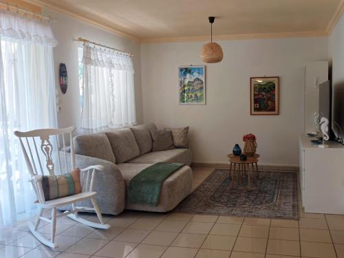 a living room with a couch and a chair at Margaréta Apartman in Balatonudvari