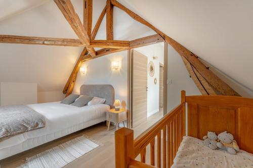 a bedroom with a white bed and a staircase at Maison Sophie for 10 guests in Pierrefonds