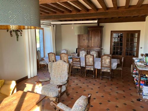 a dining room with a table and chairs at Maison d'hôtes- éco tourisme in Moux-en-Morvan