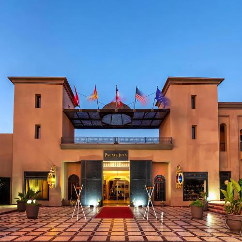 a hotel with flags on the front of it at Palais Jena Hotel & Spa in Marrakesh