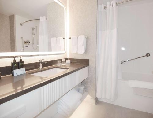 a bathroom with a sink and a shower at Coast Victoria Hotel & Marina by APA in Victoria
