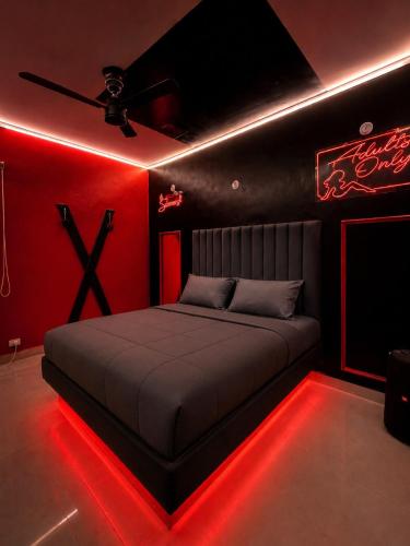 a bedroom with a bed with red lights at Canvas and Cabana - Cabo in Sonīpat