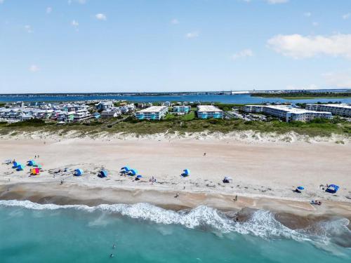 an aerial view of a beach with people and umbrellas at Beach Getaway w Pool & Private Balcony in Atlantic Beach