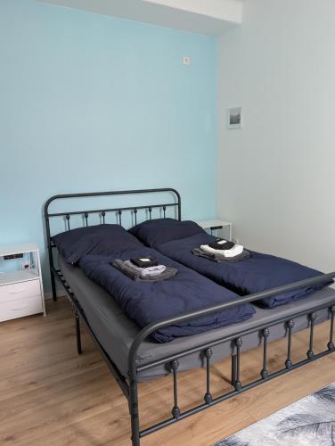 a bed with blue sheets and a metal frame at Royal Racing Suite Top 3 near Red Bull Ring in Judenburg