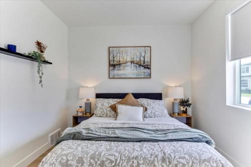 a bedroom with a bed and two windows at Stylish Pet Friendly Home for Work & Relaxation in American Fork