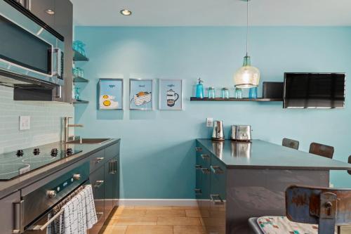 a kitchen with blue walls and a counter top at Sunset Shores Sunset Shores 246 in Carpinteria