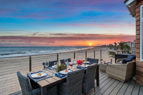 a table on a balcony with a view of the beach at Sandcastle in Carpinteria