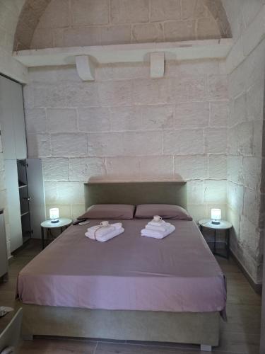 a bedroom with a bed with two towels on it at Casa Vacanza Largo 65 in Scorrano