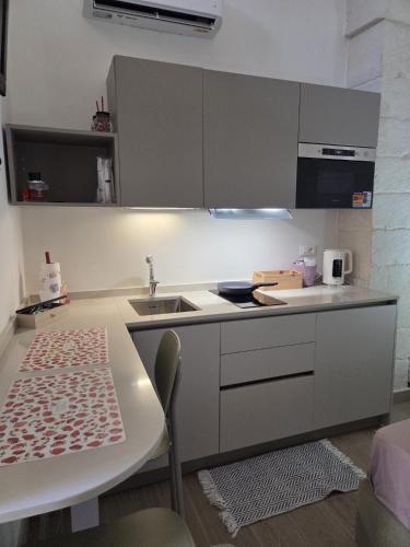 a kitchen with a sink and a counter top at Casa Vacanza Largo 65 in Scorrano