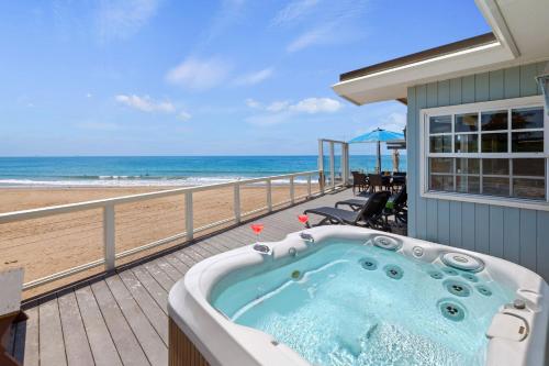 a hot tub on a deck next to the beach at Padaro Sands in Carpinteria