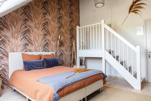 a bedroom with a bed and a white staircase at De Zuileshoeve in Dordrecht